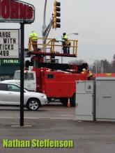 workers putting up sign in wintry mix workers putting up sign in wintry mix